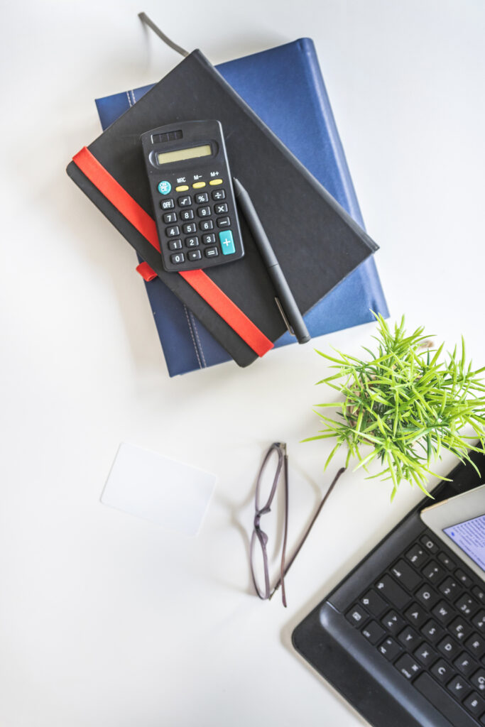 various-stationeries-eyeglasses-potted-plant-tabletop